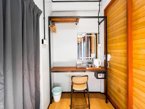 a room with a desk and a chair next to a door at A Coral Reefs Resort Langkawi by Manhattan Group in Pulau Chupak