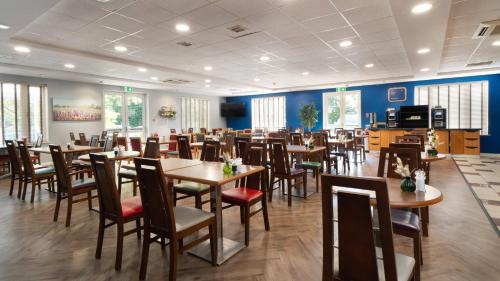 a dining room filled with tables and chairs at Holiday Inn Express Poole by IHG in Poole