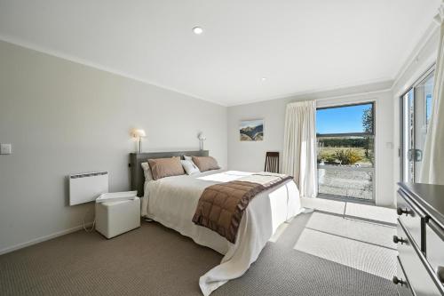 Katil atau katil-katil dalam bilik di Hurunui River Retreat - Tussock Cottage
