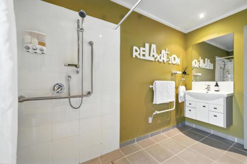 a bathroom with a shower and a sink at Hurunui River Retreat - Flax Cottage in Hurunui