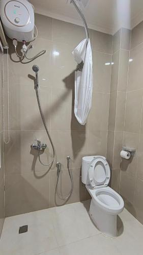 a bathroom with a shower and a toilet at Berkat Surya Dewa Guest House in Benuaanyar