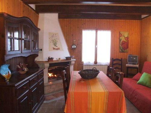 a living room with a table and a fireplace at Valleprata in Sellano