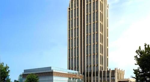 a tall building in front of two other buildings at Zhejiang D.H Hotel in Jiaxing