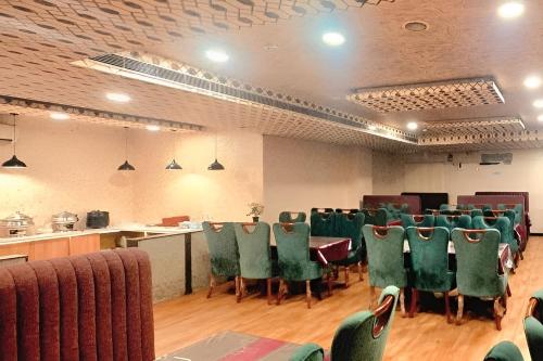 a conference room with green chairs and a table in it at Hotel SM Deccan Park Airport Zone Shamshabad Hyderabad in Shamshabad