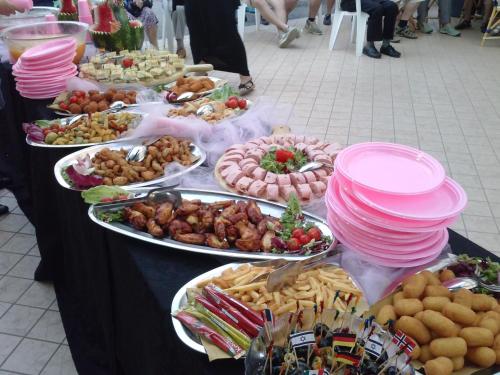 a buffet of food on a black table at Hotel Sandra in Rimini