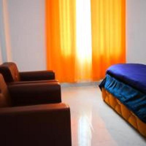 a living room with a couch and a bed at Hotel The Yamuna by StayApart in Kharsālī