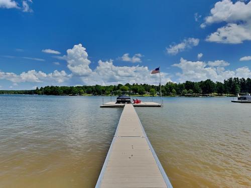 a dock with a boat in the water at Crows Point Lakehouse in Swanton