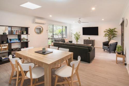 a living room with a table and a couch at Gwens Hidden Gem in Busselton