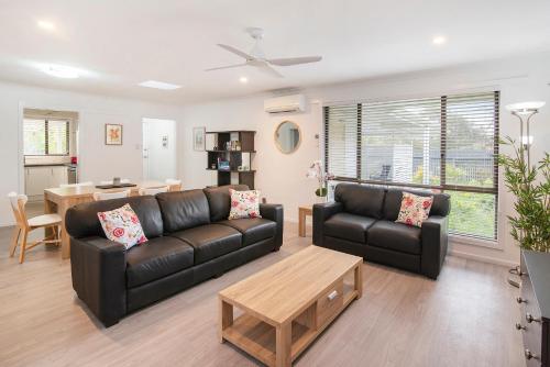 a living room with a couch and a table at Gwens Hidden Gem in Busselton