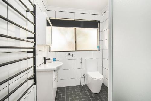 a bathroom with a toilet and a sink at Gwens Hidden Gem in Busselton
