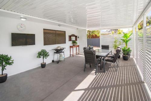 a covered patio with a table and chairs at Gwens Hidden Gem in Busselton