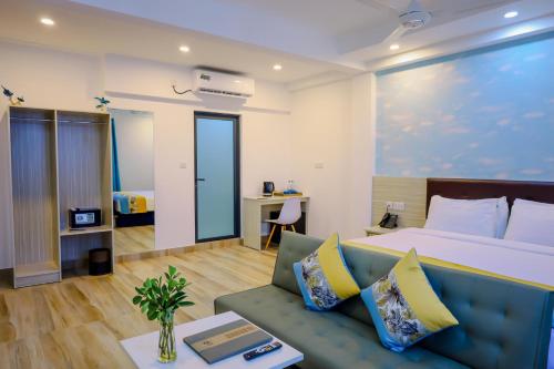 a hotel room with a bed and a couch at h78 Iru in Hulhumale