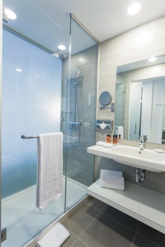 a bathroom with a sink and a shower at Riu Plaza New York Times Square in New York
