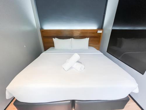 a bed in a small room with a roll of toilet paper on it at A Coral Reefs Resort Langkawi by Manhattan Group in Pulau Chupak