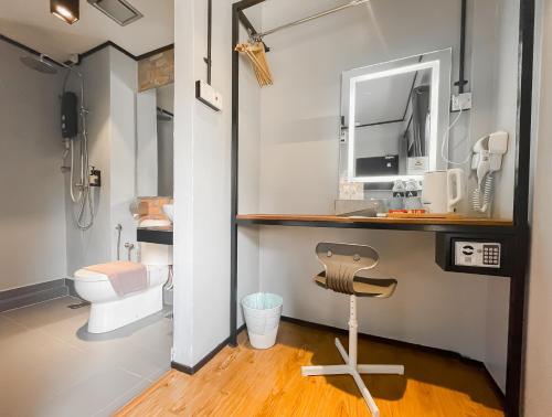 a bathroom with a toilet and a sink at A Coral Reefs Resort Langkawi by Manhattan Group in Pulau Chupak