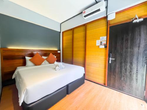 a bedroom with a bed and a sliding glass door at A Coral Reefs Resort Langkawi by Manhattan Group in Pulau Chupak