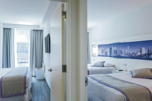 a hotel room with two beds and a window at Riu Plaza New York Times Square in New York