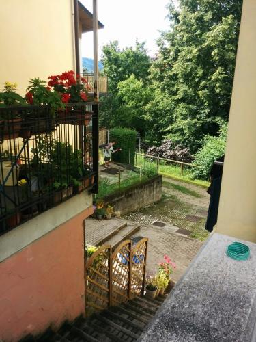 a stairway with a balcony with flowers on it at Casetta next to the Creek Dino Buzzati in Belluno