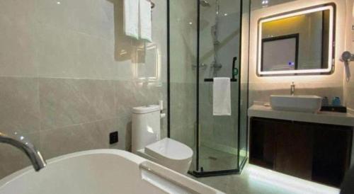 a bathroom with a sink and a toilet and a shower at GreenTree Inn Express Datong High-Speed Railway Station Wanda Plaza Fangte in Datong