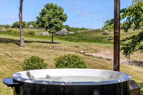 a hot tub with a view of a field at Beautiful House In Fantastic Surroundings in Nykøbing Mors