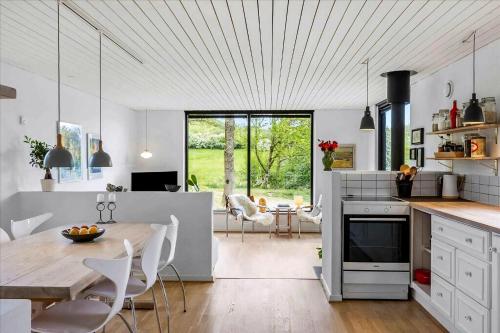 a kitchen and dining room with a table and chairs at Beautiful House In Fantastic Surroundings in Nykøbing Mors