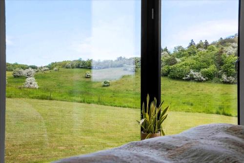 a view of a field from a bedroom window at Beautiful House In Fantastic Surroundings in Nykøbing Mors