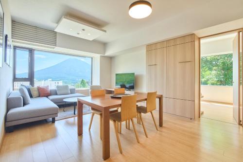 a living room with a table and a couch at Ki Niseko in Kutchan