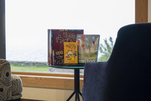 a table with books on it next to a window at waku terrace in Fukui