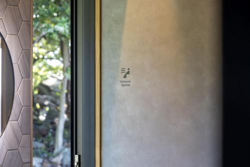 a door with a sign on the side of a window at waku terrace in Fukui