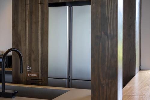a kitchen with a stainless steel refrigerator at waku terrace in Fukui