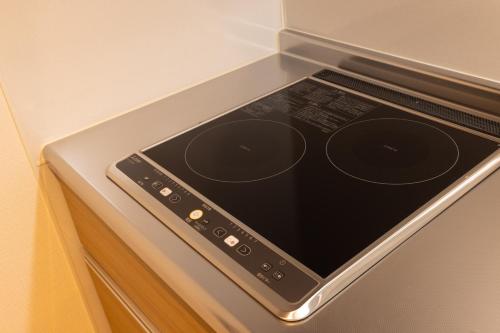 a tablet is sitting on top of a stove at Tomattoco KASUMI in Yamagata