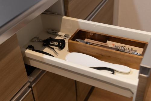 a drawer in a kitchen with a wooden box at Tomattoco KASUMI in Yamagata
