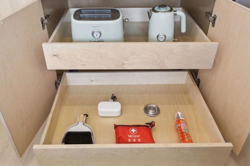 a drawer in a cupboard with a kitchen appliance at Casa Riviera - Boutique Apartments in Downtown Santa Barbara in Santa Barbara