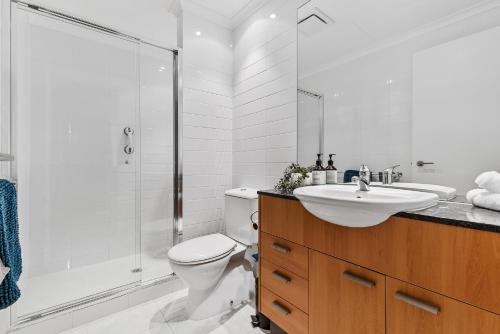 a bathroom with a toilet and a sink and a shower at Dolphin Harbour Haven-family Friendly-canal Front in Mandurah