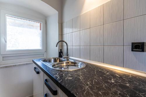 a bathroom with a sink and a window at Giannina in Cres