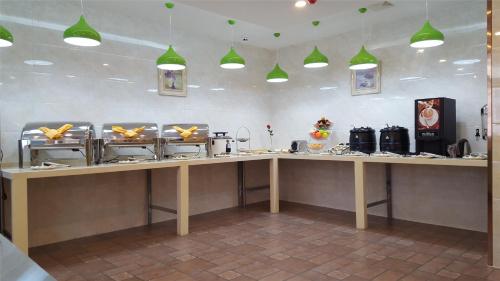 a kitchen with a counter with food on it at Vatica Jiangsu Lianyungang Haizhou District Government Zhongyin Mingdu Hotel in Lianyungang