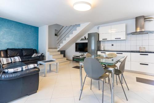 a kitchen and living room with a couch and a table at Giannina in Cres
