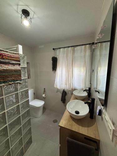 a bathroom with a sink and a toilet at Casa rural Los Rosales in Lanjarón