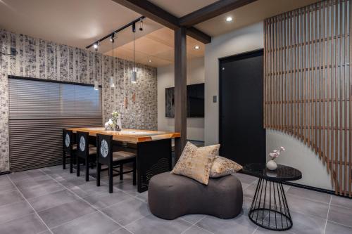 a dining room with a table and a chair at JAPAVISTA Hinata in Osaka