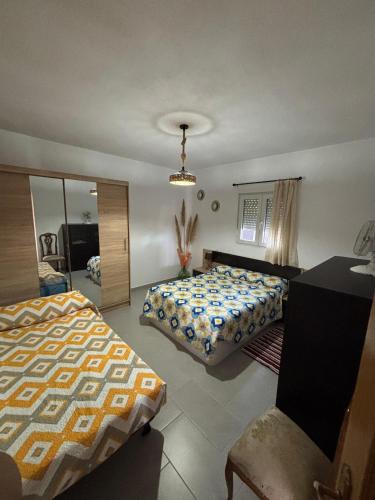 a bedroom with two beds and a mirror at Casa rural Los Rosales in Lanjarón