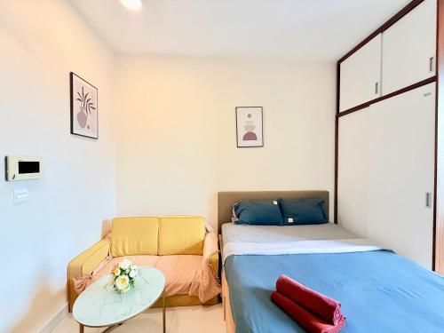 ホーチミン・シティにあるCBD Luxury Apartment In Rivergate Buildingのベッドとソファのある小さな寝室