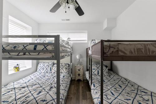 two bunk beds in a bedroom with a ceiling fan at 212 E Toledo Ave in Wildwood Crest