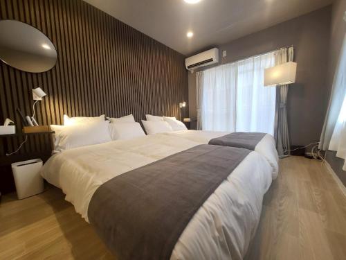 Ένα ή περισσότερα κρεβάτια σε δωμάτιο στο GuestHouseAQUA101