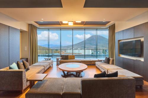 a large living room with couches and a large window at Ki Niseko in Kutchan