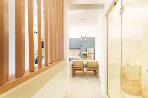 a dining room and kitchen with a table and chairs at ARTEMIS SUITE in Agia Marina