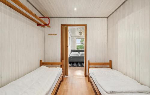 two beds in a room with a bedroom at Awesome Home In Sydals With Wifi in Østerby