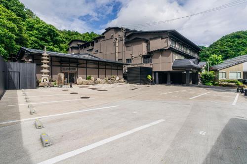 an empty parking lot in front of a building at Shinzan Kinosaki in Toyooka