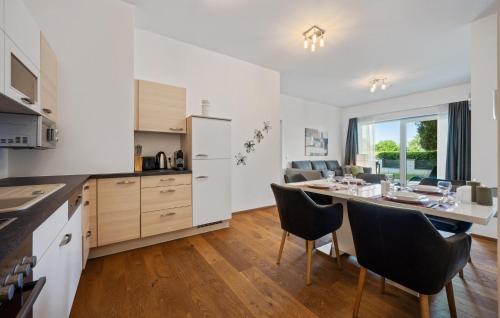 a kitchen and dining room with a table and chairs at Ferienwohnung 90M² in Pörtschach am Wörthersee