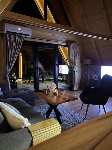 a living room with a couch and a table at Vila Jezero-Jajce in Jezero