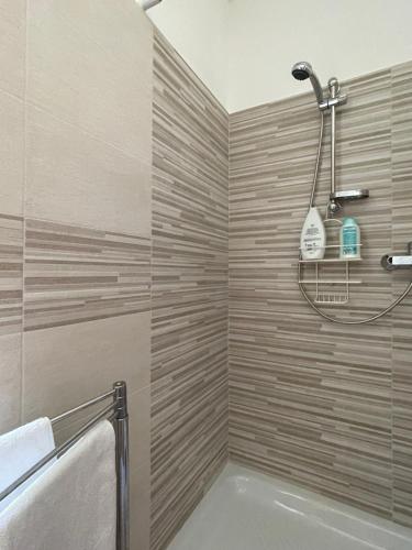 a bathroom with a shower and a bath tub at Casa di Adele in Brittoli